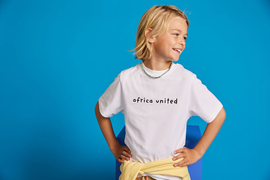 Happy boy wearing Organic Cotton White Africa United T-Shirt be BE.Kids